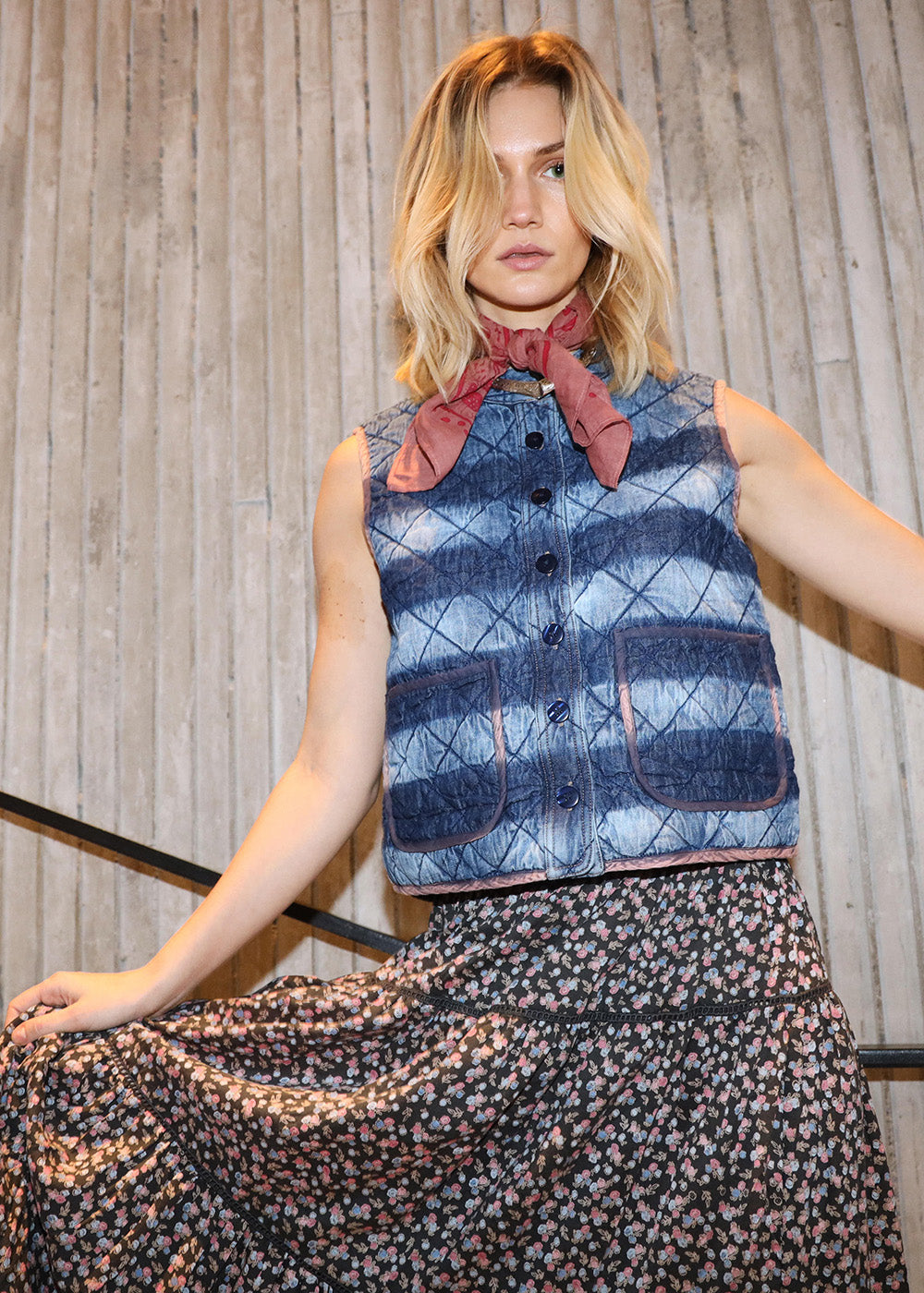 Model wearing a denim vest with stripes together with a skirt with flower print 